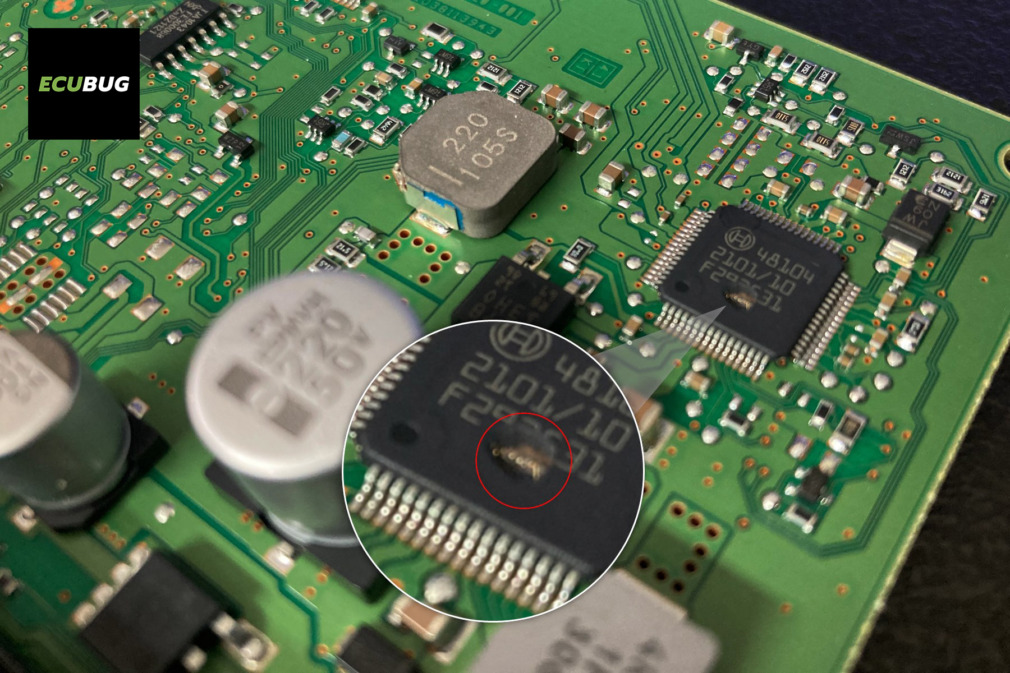 Macro view of a burnt Bosch IC chip on a Mercedes Actros CPC5 module, illustrating physical ECU hardware failure analyzed during tool development.